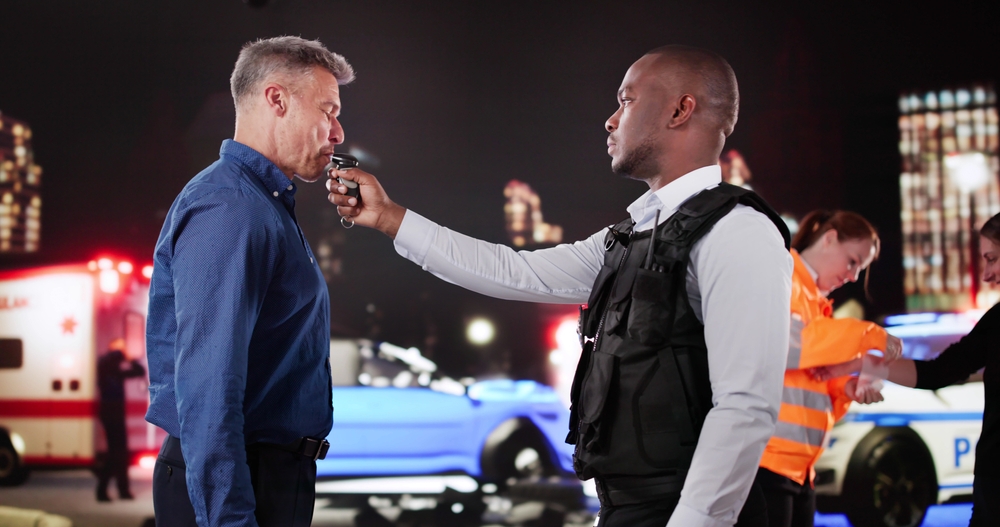Police,Officer,Conducts,Breathalyzer,Test,On,Suspected,Impaired,Driver,In-charge.
