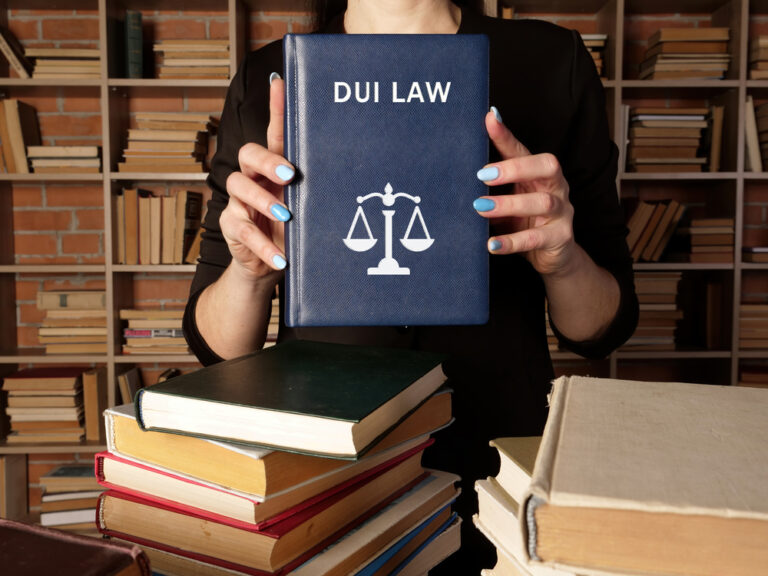 Lawyer,Holds,Dui,Law,Book.,Among,Other,Names,,The,Criminal