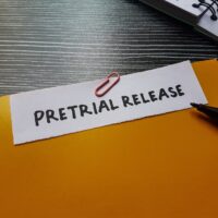 PretrialReleaseWrittingOnTableBackground